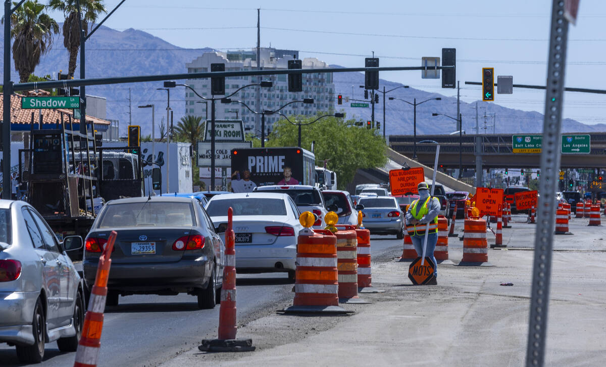 A traffic control worker looks up the street about a road project along West Charleston Blvd. a ...