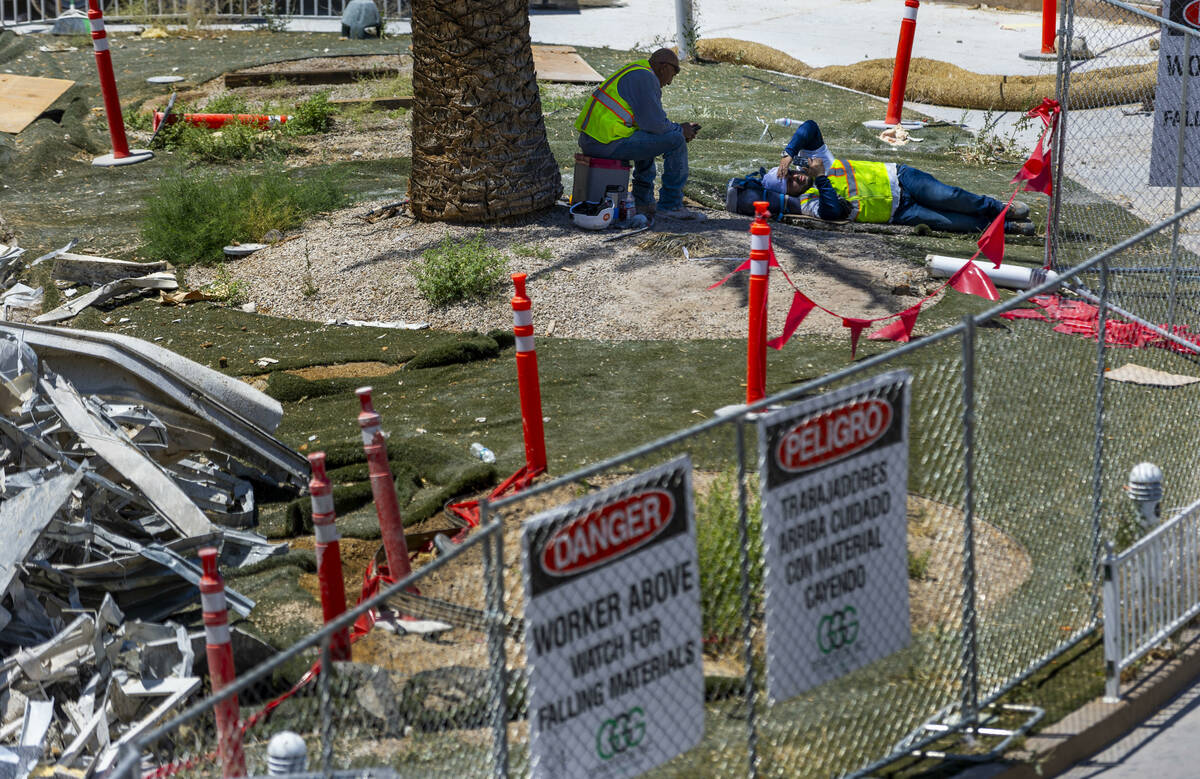 A crew takes lunch in the shade at the Tropicana Las Vegas demolition as workers use protection ...
