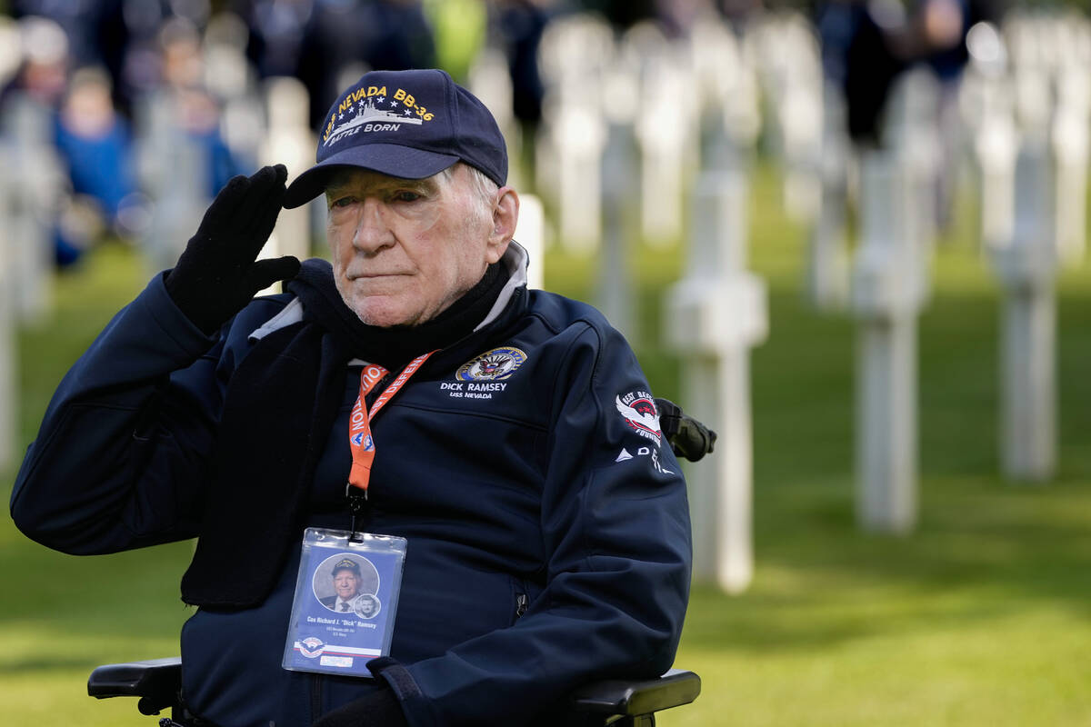 World War II and D-Day veteran Richard Ramsey salutes as he visits graves at the Normandy Ameri ...