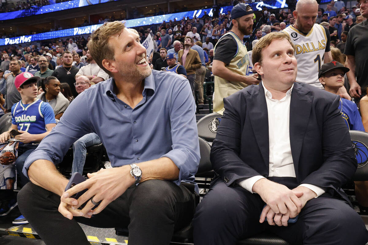 Dirk Nowitzki, former Mavericks player, left, and Patrick Dumont, new Mavericks governor, sit ...