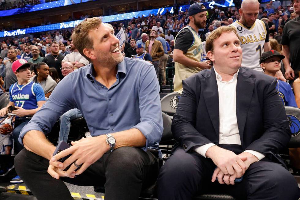 Dirk Nowitzki, former Mavericks player, left, and Patrick Dumont, new Mavericks governor, sit ...