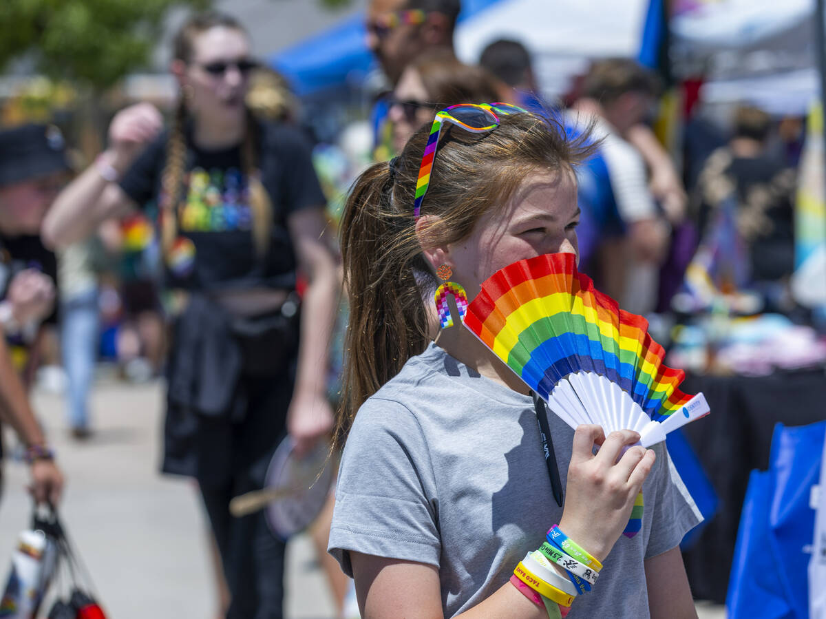 A girl walks about with a rainbow fan during the 4th Annual Henderson Pride Festival about Cit ...