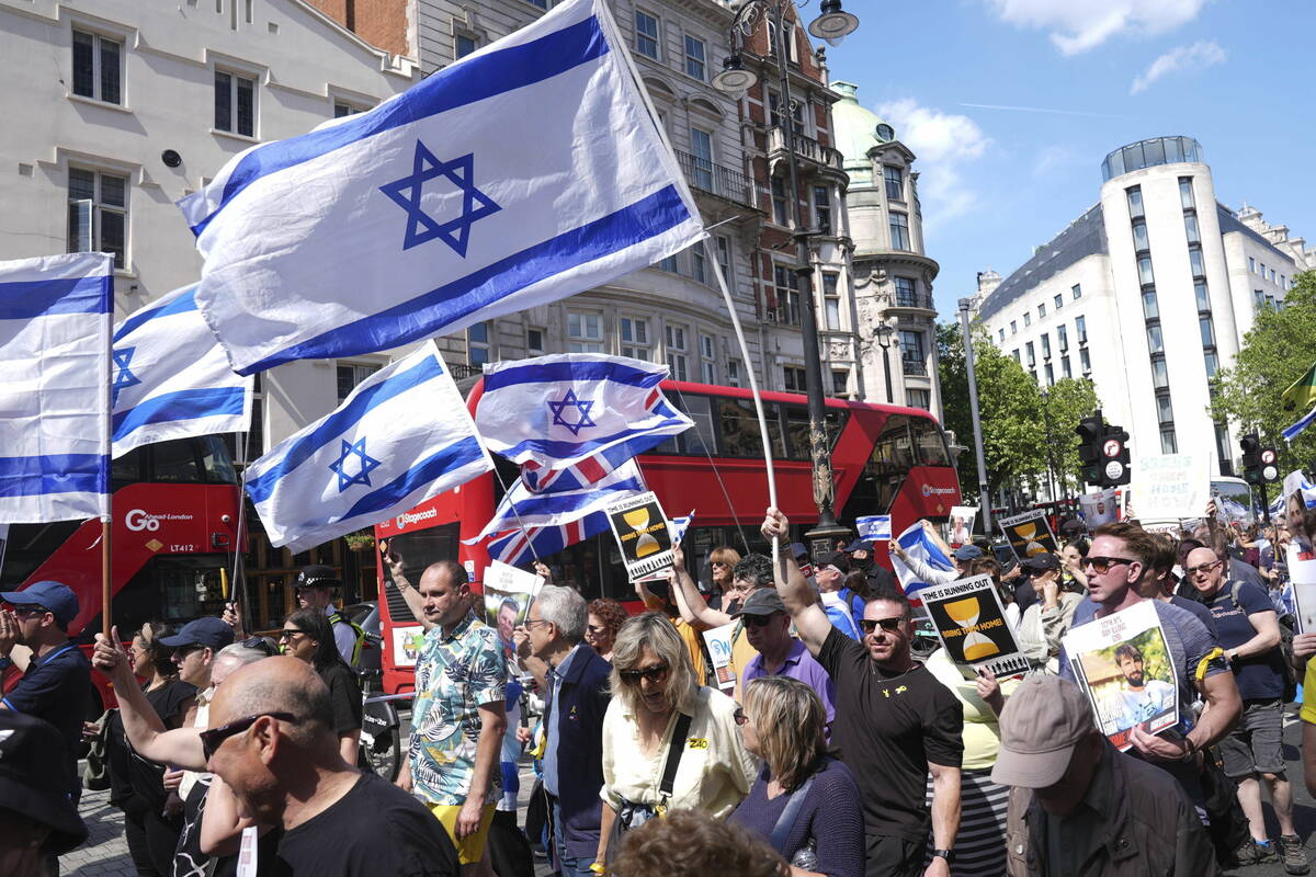 People take part in a Bring Hostages Home event in central London, Sunday, June 2, 2024, to dem ...