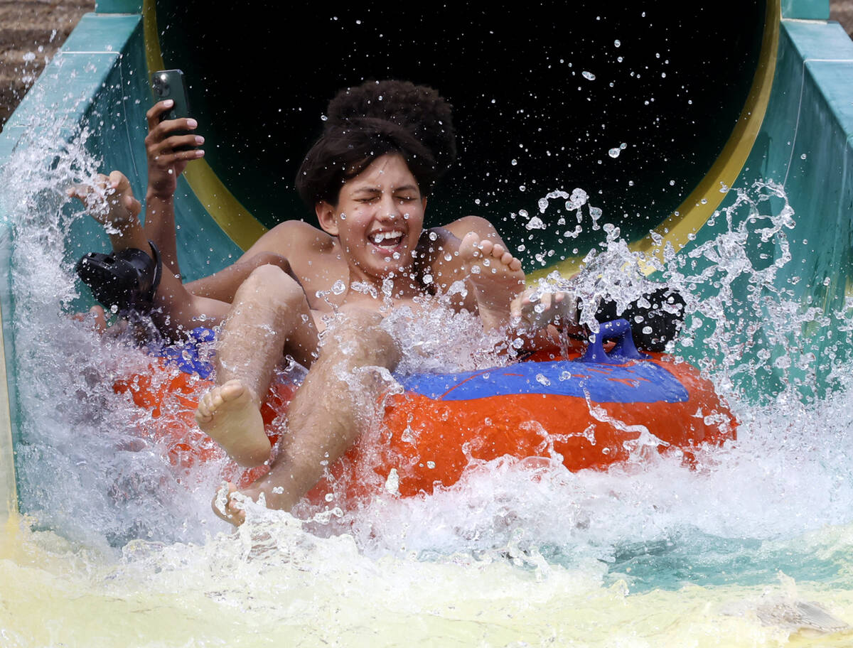 Miguel Guzman plays on a waterslide at Cowabunga Canyon waterpark, on Monday, June 3, 2024, in ...