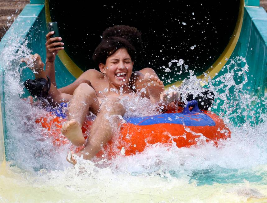 Miguel Guzman plays on a waterslide at Cowabunga Canyon waterpark, on Monday, June 3, 2024, in ...