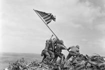 U.S. Marines of the 28th Regiment, 5th Division, raise a U.S. flag atop Mount Suribachi, Iwo Ji ...
