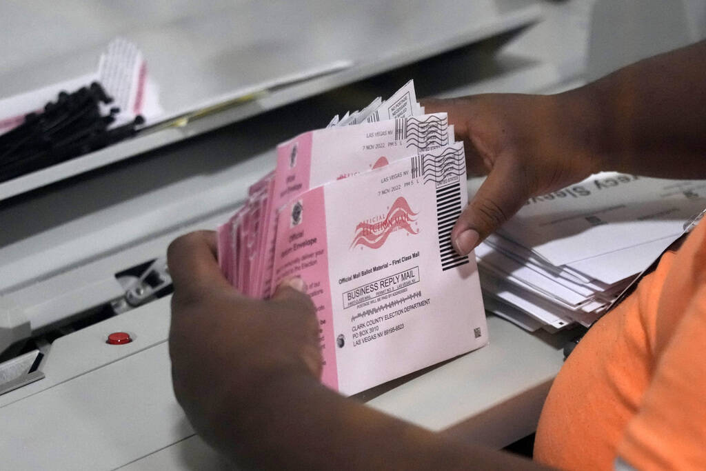 FILE - An election worker prepares mail-in ballots at the Clark County Election Department on N ...