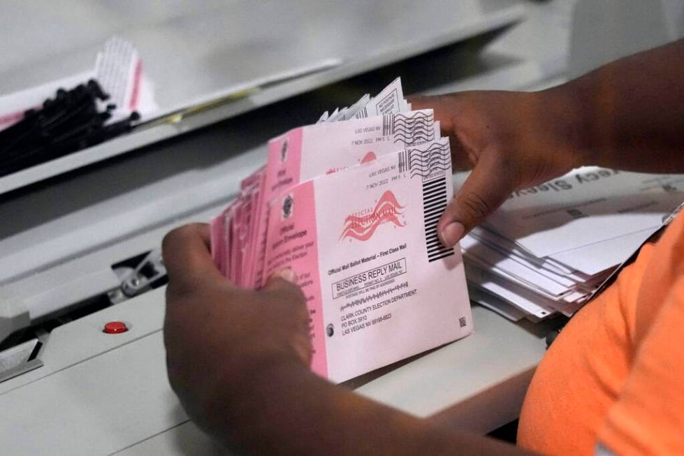 FILE - An election worker prepares mail-in ballots at the Clark County Election Department on N ...