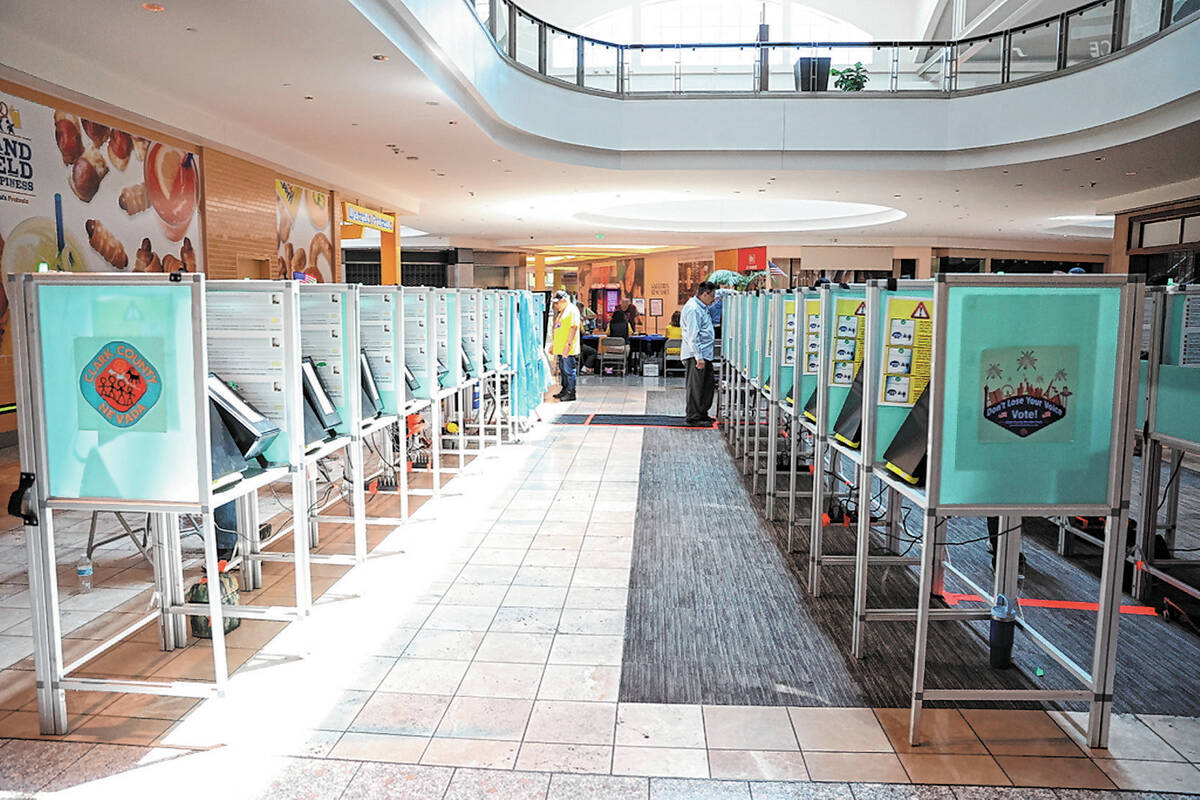 Voters cast their ballots during the early voting period at a polling location at the Galleria ...