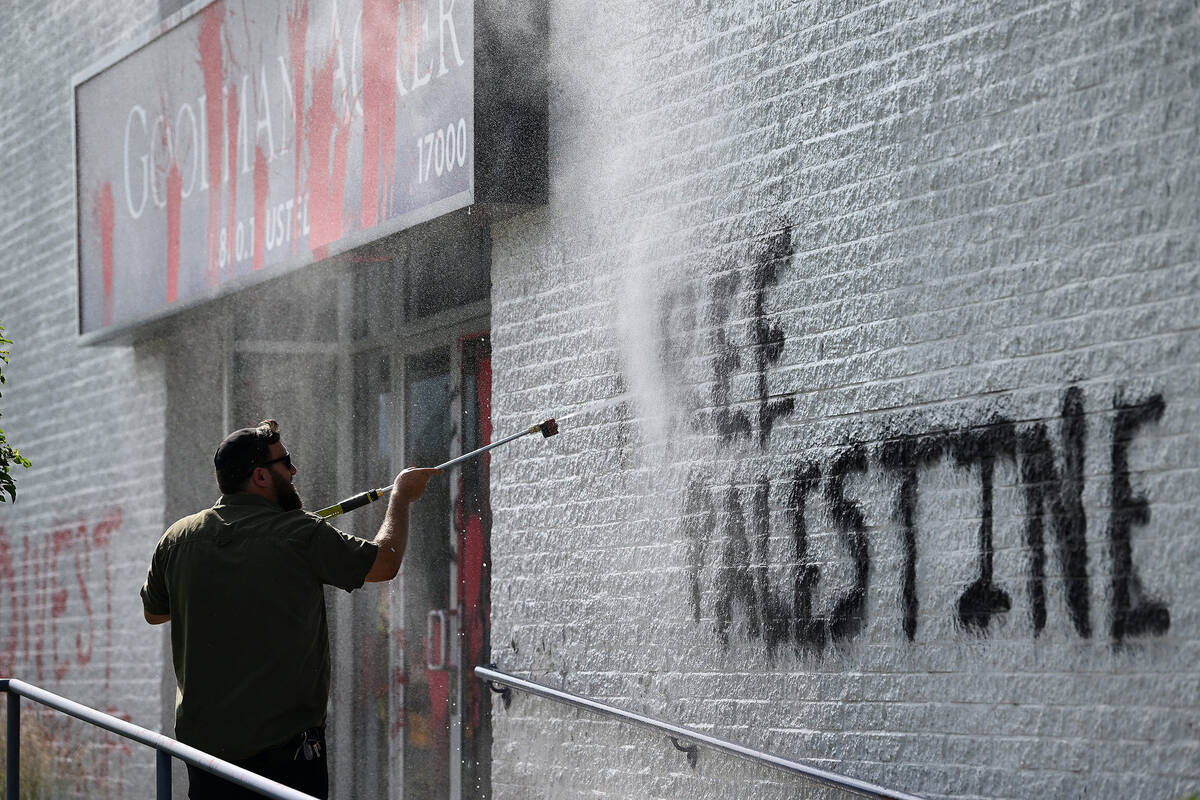 A volunteer who only wanted to give the name Josh power washes ìFree Palestineî from ...