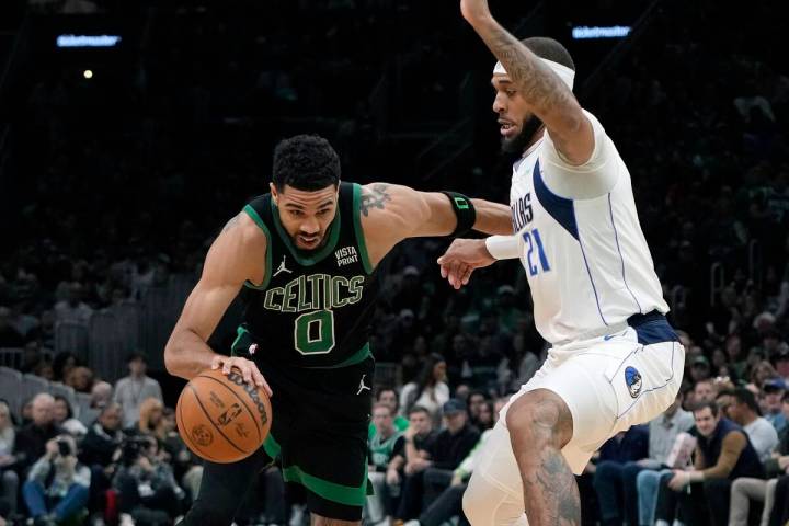 Boston Celtics' Jayson Tatum (0) drives past Dallas Mavericks' Daniel Gafford (21) during the f ...