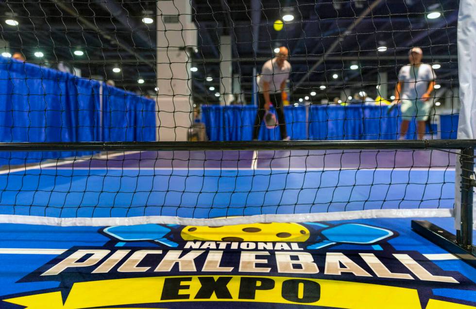 Attendees play a round of doubles on a practice court during the World Pickleball Convention wi ...