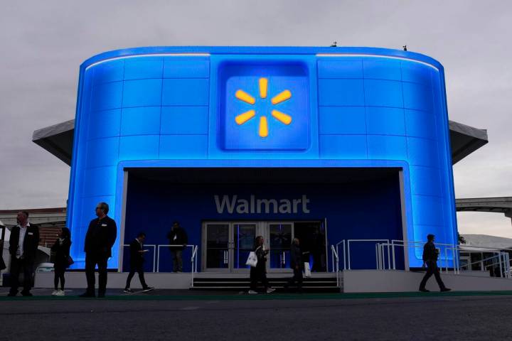 People walk by the Walmart booth during the CES tech show Tuesday, Jan. 9, 2024, in Las Vegas. ...