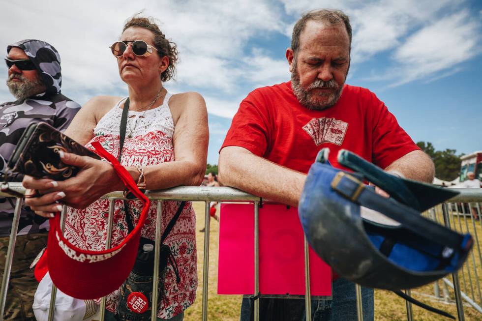 Trump supporters bow their heads in prayer at a rally for the former president at Sunset Park o ...