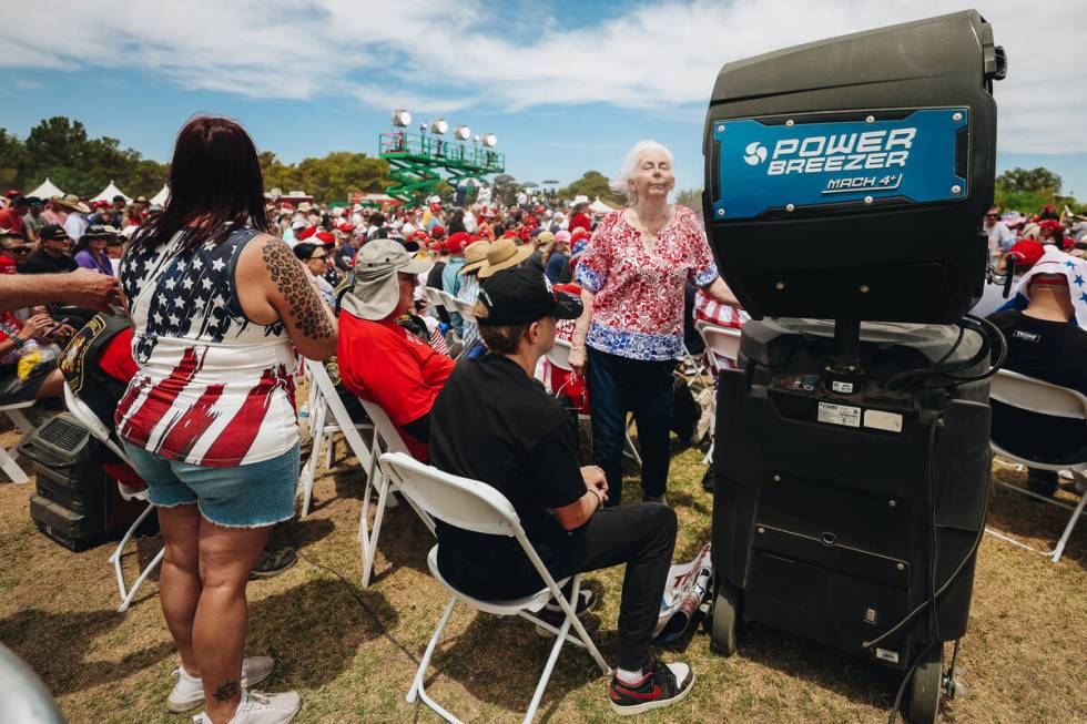 Trump supporters cool off by a misting fan at a rally for Former President Donald Trump at Suns ...