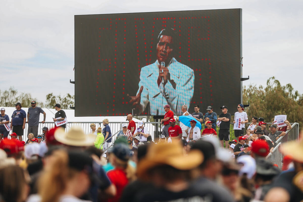 A music video for Elvis’ “If I Can Dream” plays before a rally for former ...