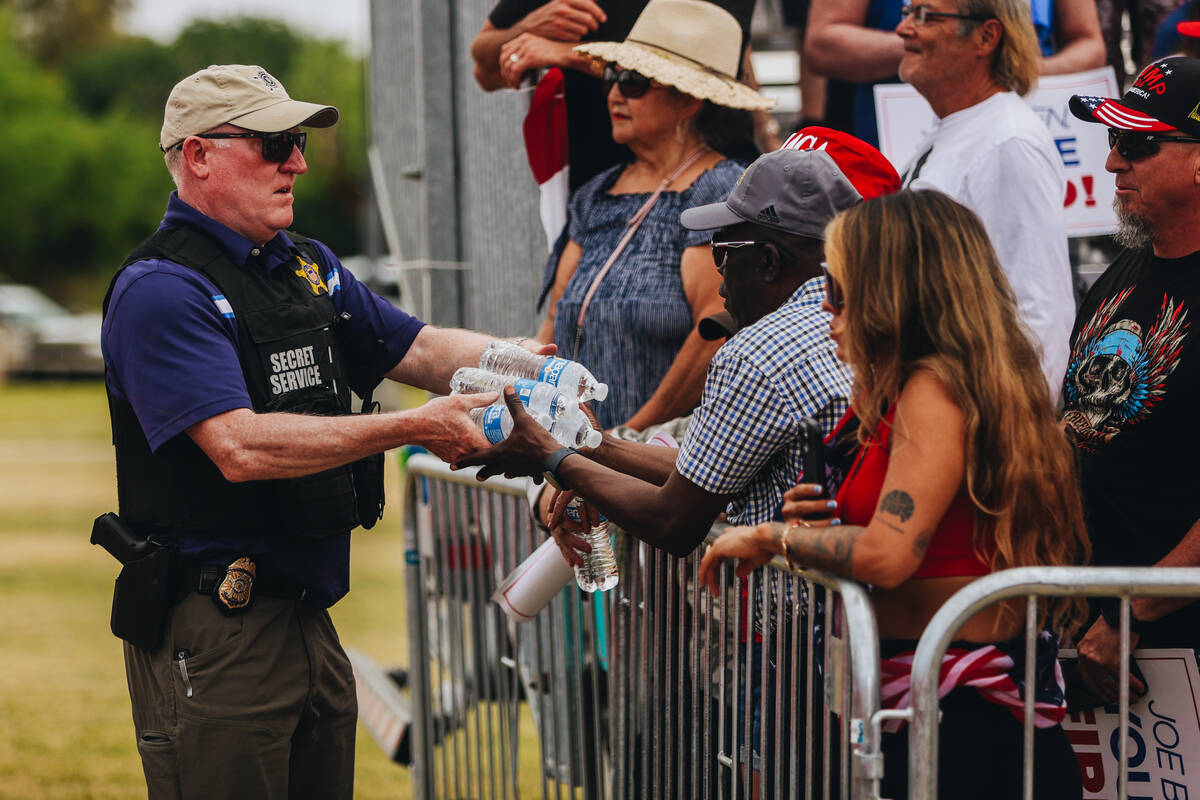 A police officer hands out water at a rally for former President Donald Trump at Sunset Park on ...