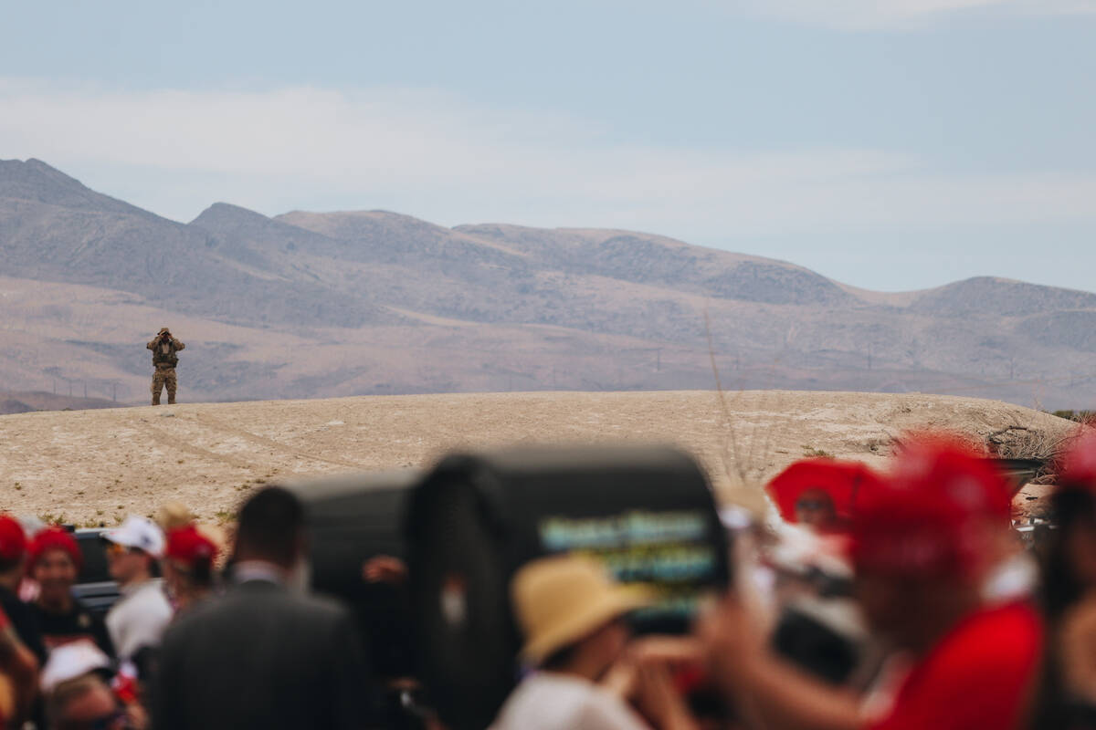 A sniper is seen on a hill during a rally for former President Donald Trump at Sunset Park on S ...