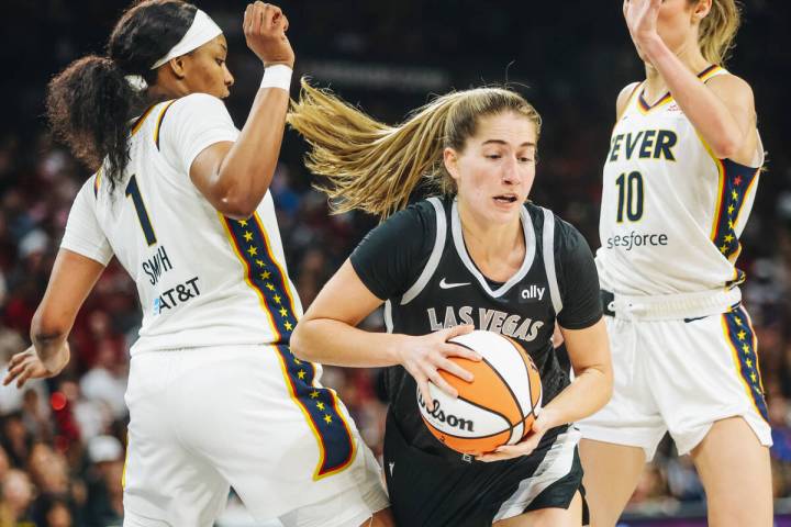 Aces guard Kate Martin (20) drives through Indiana Fever defenders during a game between the Ac ...