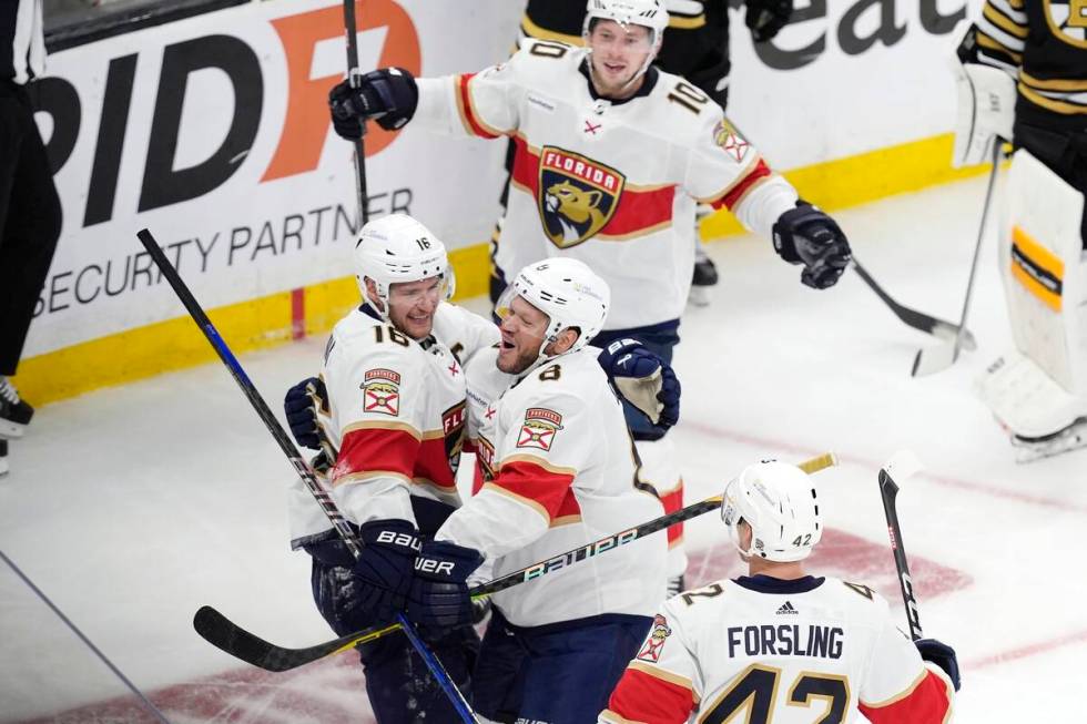 Florida Panthers' Aleksander Barkov (16) celebrates after his goal with Kyle Okposo (8), Gustav ...