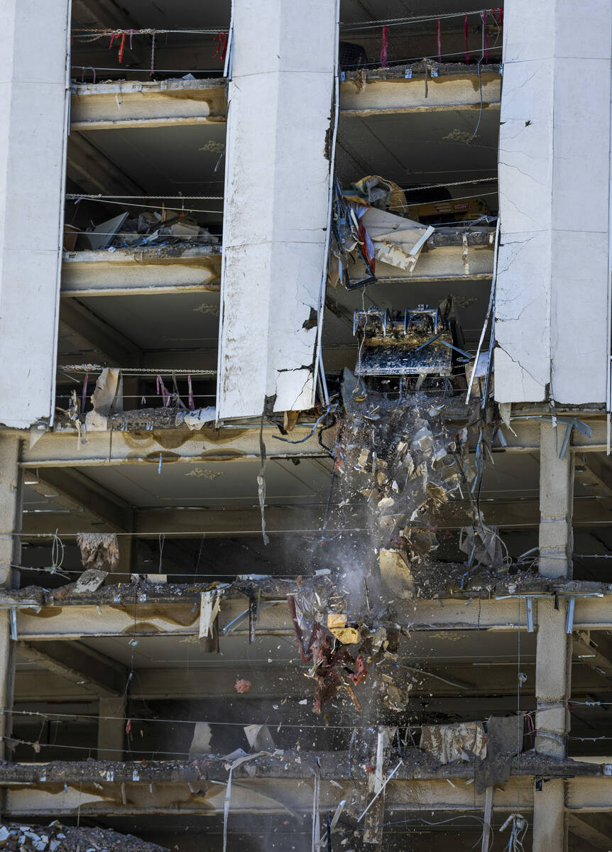Debris is pushed out to a pile below as lower floors at the Tropicana are stripped of all inter ...