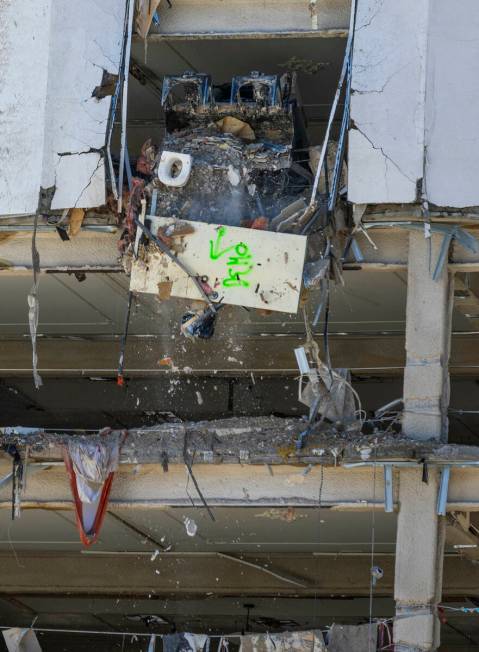 Debris is pushed out to a pile below as lower floors at the Tropicana are stripped of all inter ...