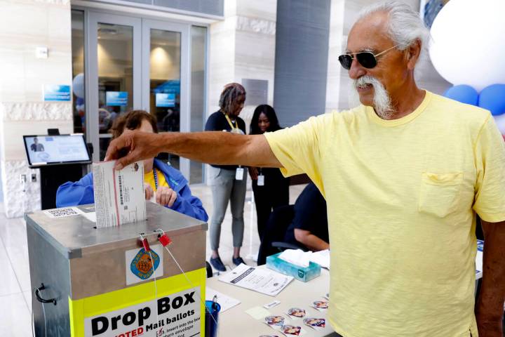 Patrick Jones of Las Vegas casts his ballot at a drop box during early voting at Las Vegas Cit ...