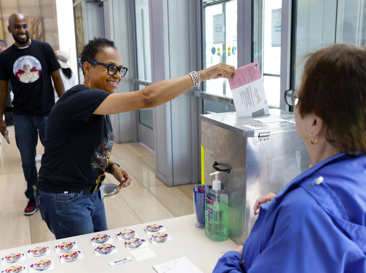 Kelly Woods of Las Vegas casts her ballot at a drop box as Beverly Mourachian, right, a volunte ...