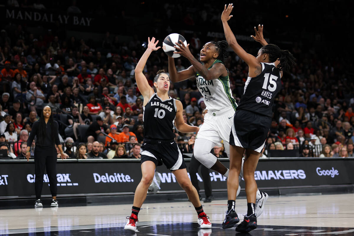 Seattle Storm guard Jewell Loyd (24) shoots against Las Vegas Aces guard Kelsey Plum (10) and g ...
