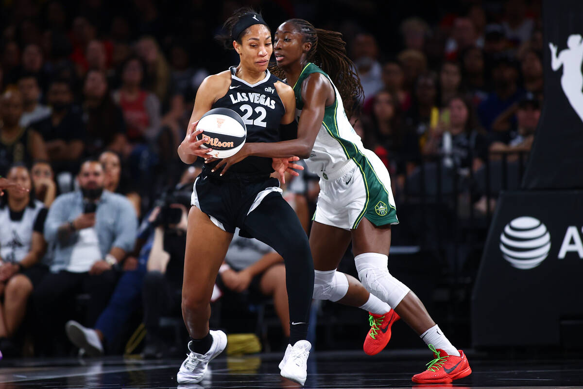 Las Vegas Aces center A'ja Wilson (22) struggles to keep the ball against Seattle Storm center ...