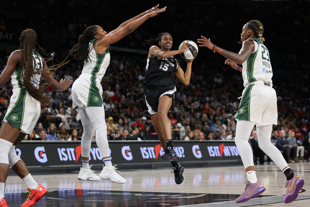 Las Vegas Aces guard Tiffany Hayes (15) looks to pass while Seattle Storm forward Nneka Ogwumik ...