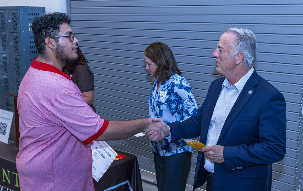 Student Nathaniel Solis shakes hands with Governor Joe Lombardo after receiving an award for be ...