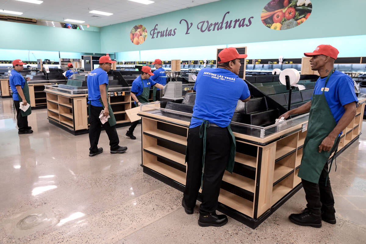 Employees work to prepare for the reopening of the La Bonita Supermarket at 2500 East Desert In ...