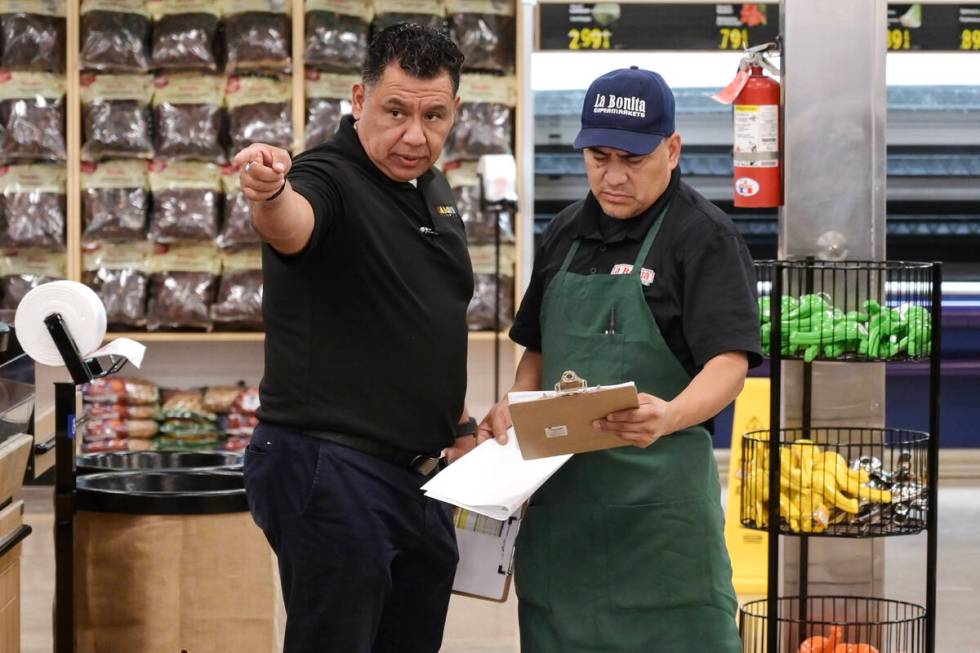 Silverio Barrera, left, and Salvador Durantes discuss stocking while preparations continue Frid ...