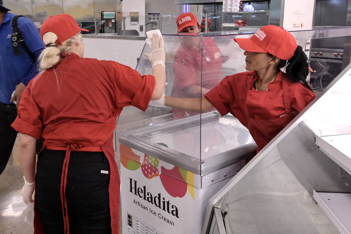 Workers clean an ice cream chest while preparations continue Friday, June 7, 2024, for the reop ...