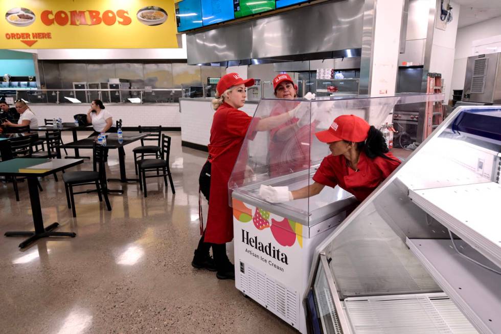 Workers clean an ice cream chest while preparations continue Friday, June 7, 2024, for the reop ...