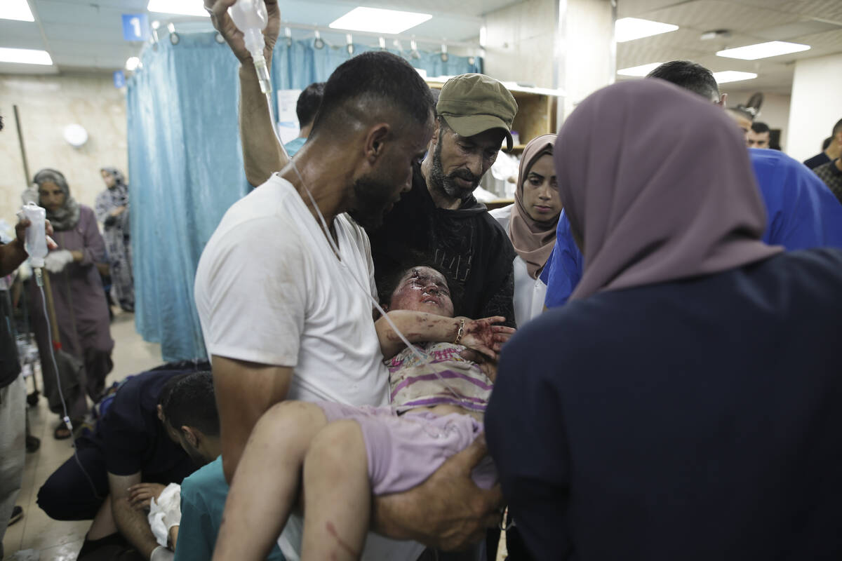 Palestinians wounded in the Israeli bombardment of the Gaza Strip arrive at al-Aqsa Hospital in ...