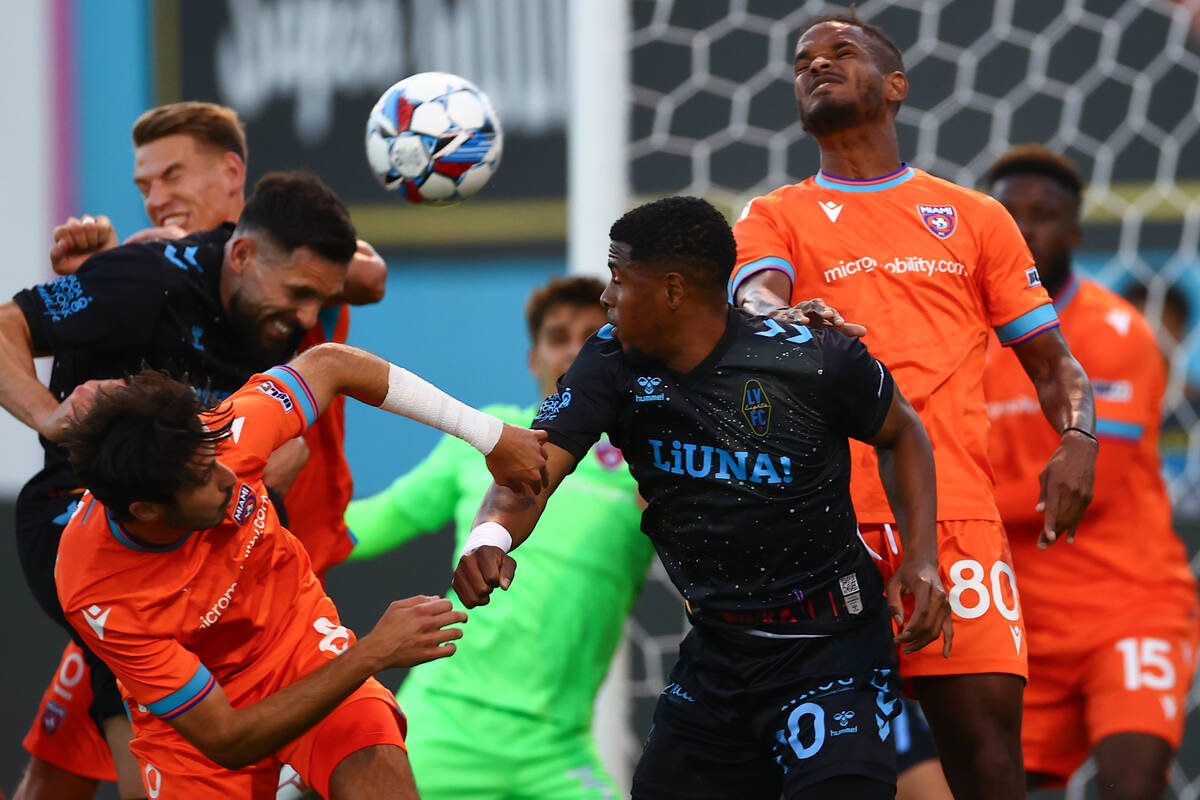 Miami FC and Las Vegas Lights FC battle for a header on a Lights penalty kick during a soccer m ...