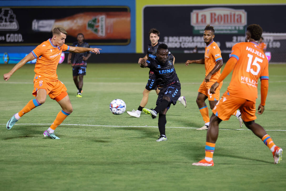 Las Vegas Lights FC forward Solomon Asante attempts a goal while Miami FC defenders close in on ...