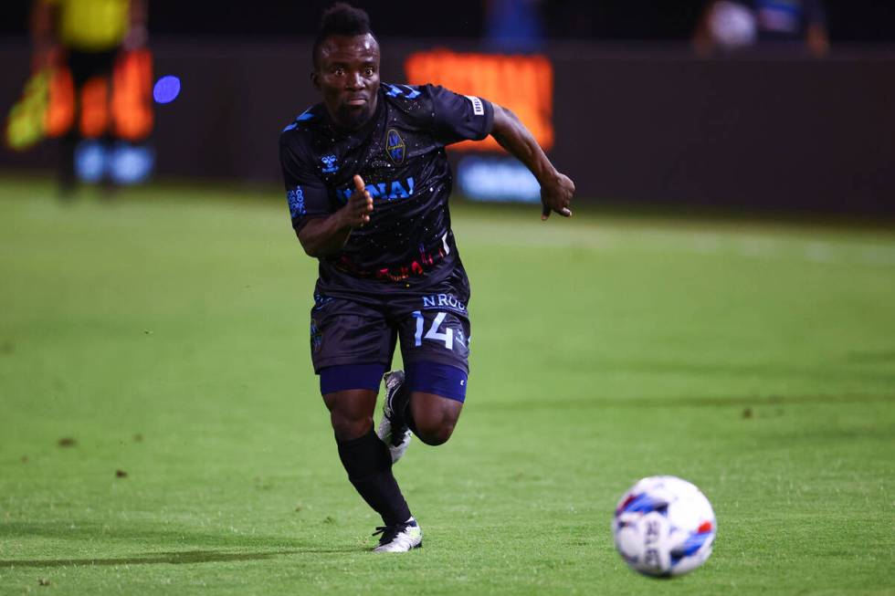 Las Vegas Lights FC forward Solomon Asante races for the ball during a soccer match against Mia ...