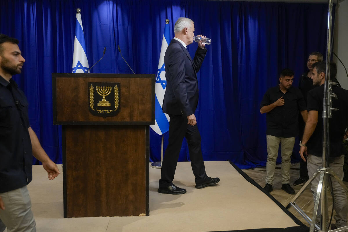 Benny Gantz, a centrist member of Israel's three-member War Cabinet drinks as he leaves after a ...