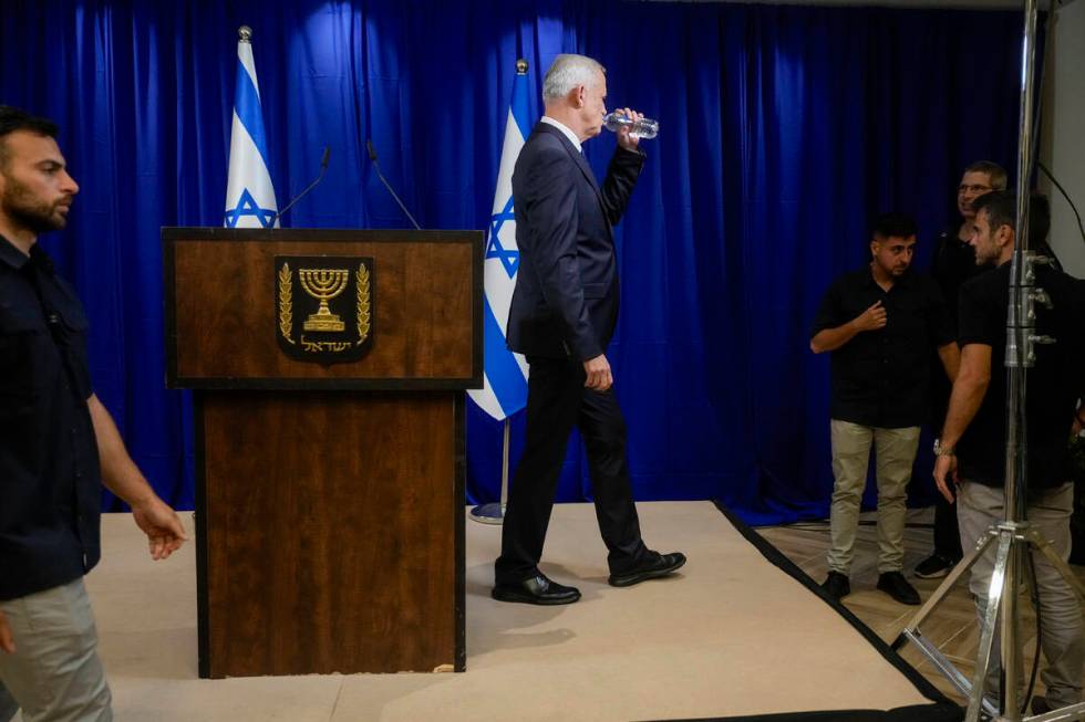 Benny Gantz, a centrist member of Israel's three-member War Cabinet drinks as he leaves after a ...
