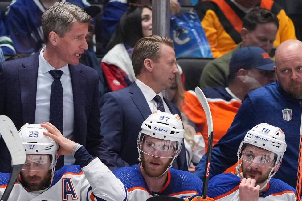 From bottom left to right, Edmonton Oilers' Leon Draisaitl, Connor McDavid and Zach Hyman sit o ...