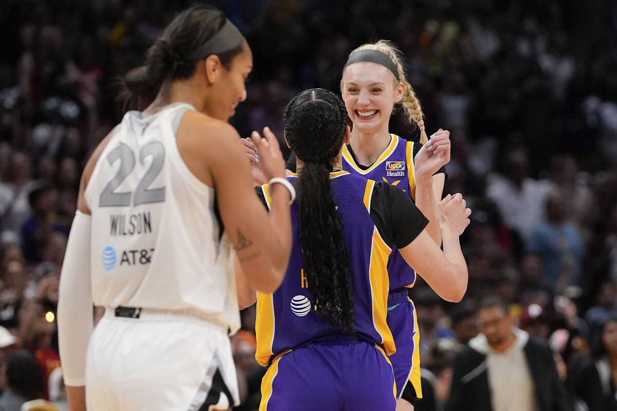 Los Angeles Sparks forwards Cameron Brink, right, and Dearica Hamby, center, celebrate after th ...