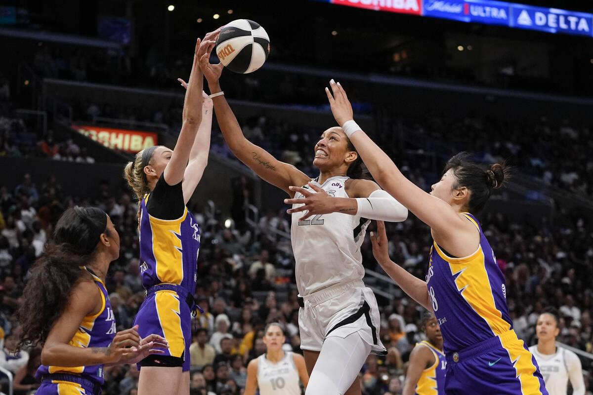 Las Vegas Aces center A'ja Wilson, second from right, shoots against, from left, Los Angeles Sp ...