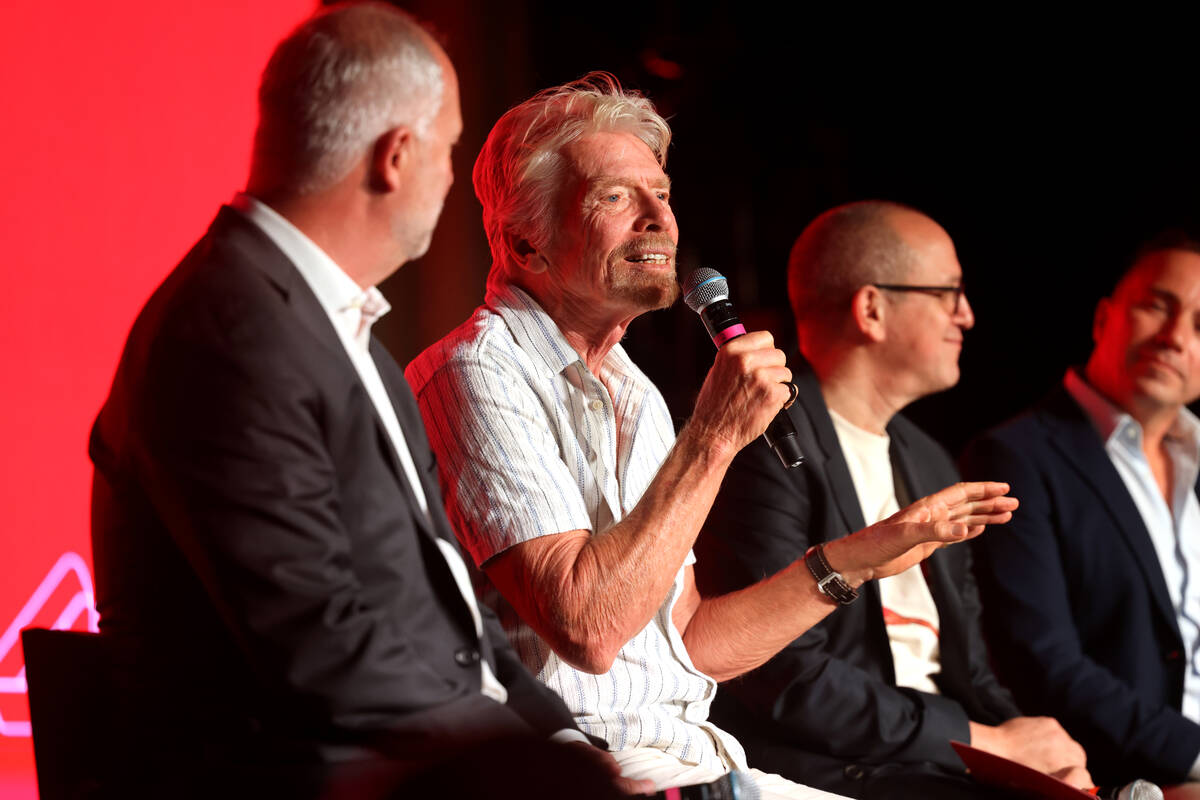 Sir Richard Branson, president and founder of Virgin Group, second from left, talks about the ...