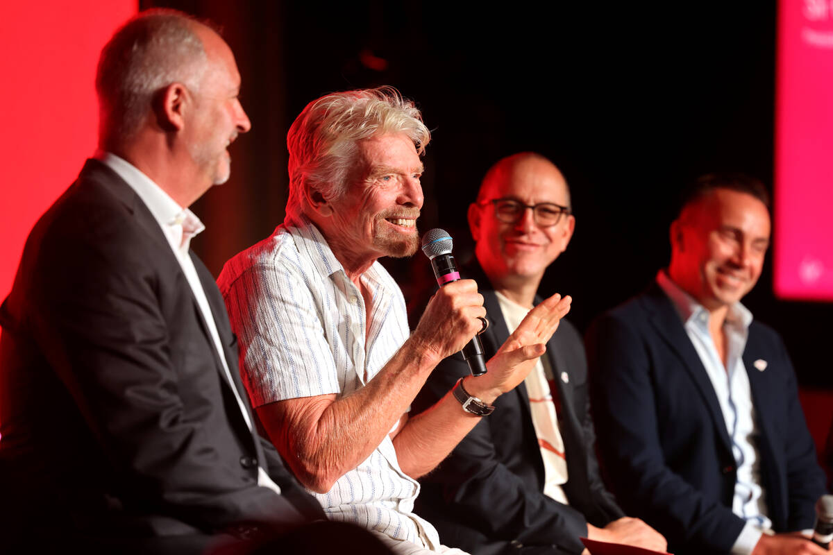 Sir Richard Branson, president and founder of Virgin Group, second from left, talks about the ...