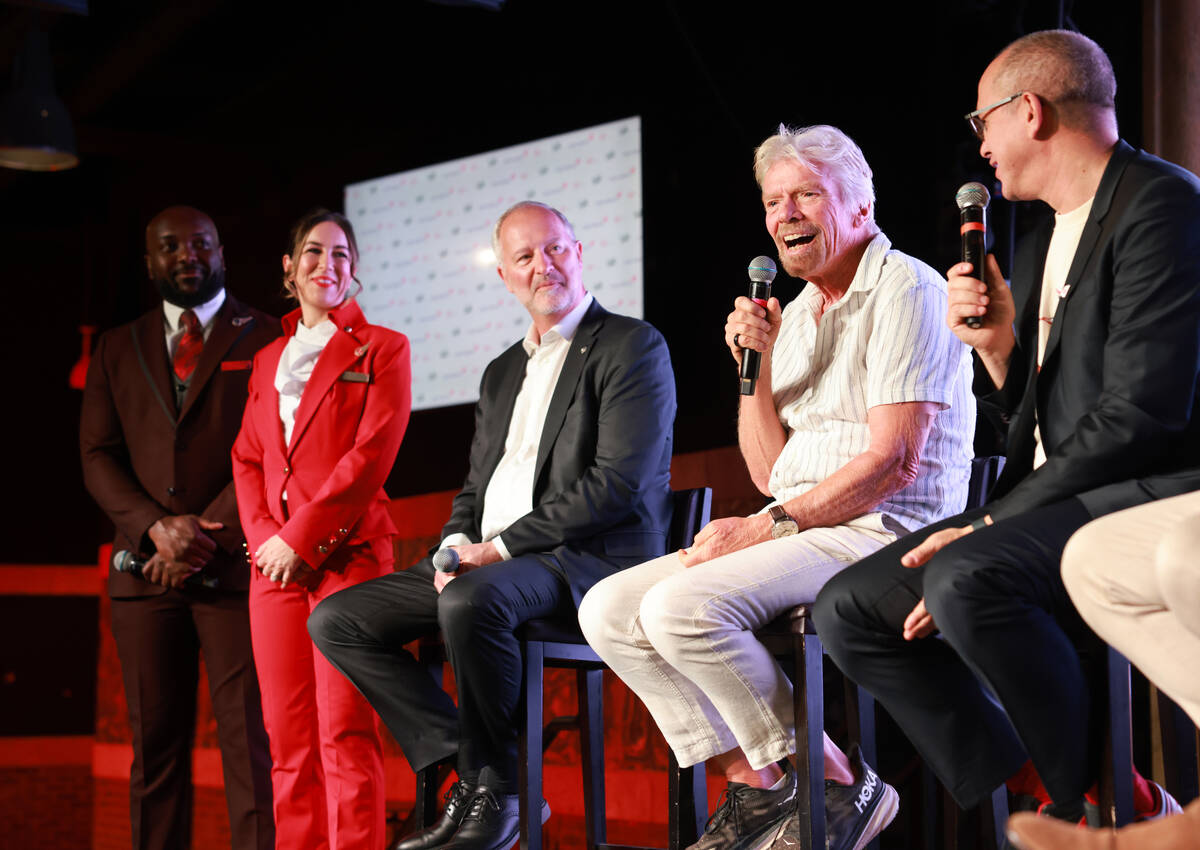 Sir Richard Branson, president and founder of Virgin Group, second from right, talks about th ...