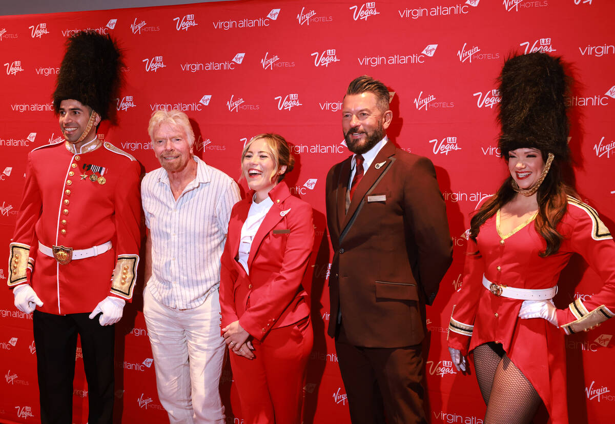 Sir Richard Branson, president and founder of Virgin Group, second from left, poses with crew ...