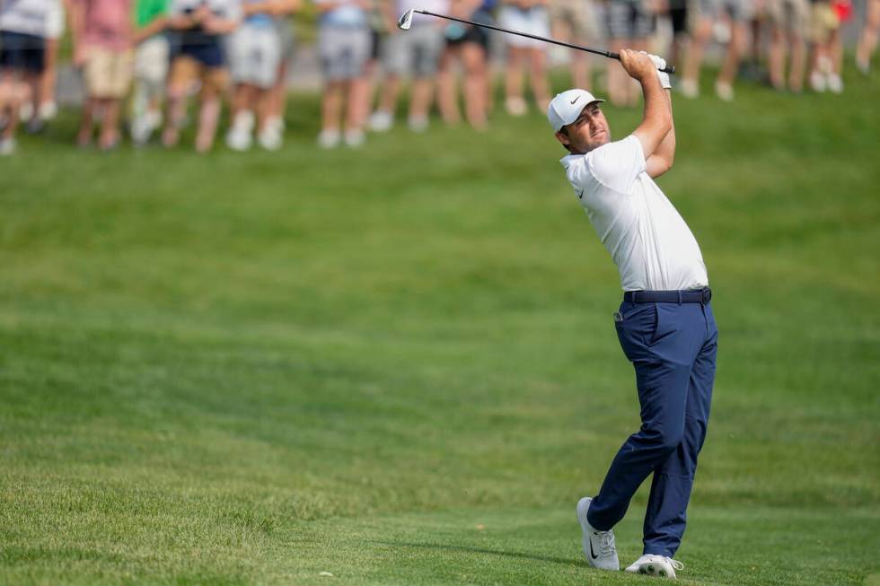 Scottie Scheffler watches his shot on the 11th fairway during the second round of the Memorial ...